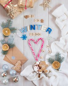 Candy Canes Christmas Decorations And Letter Tiles On A Wooden Surface