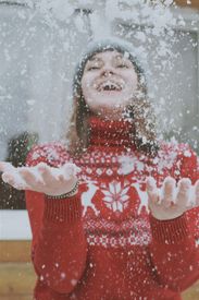 Woman In Red Sweater Having Fun With Snow