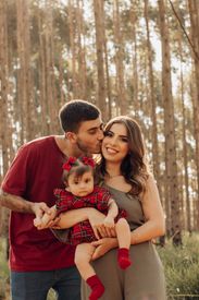 Mother And Father Standing With Baby Daughter