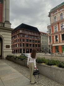Woman Strolling In Urban European Street