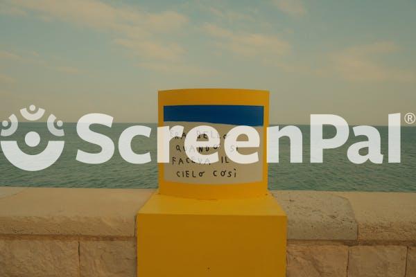 Yellow Post With Italian Text By Seaside