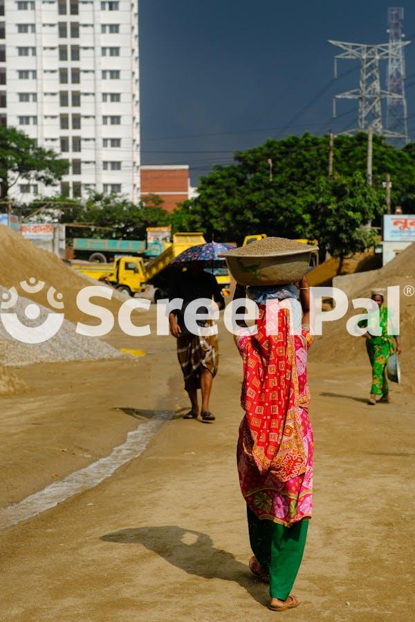 Construction Workers In Urban Setting On Sunny Day