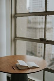 Cozy Workspace With Open Notebook By Window