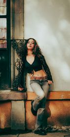 Young Woman Posing By Rustic Window