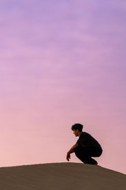 Man Reflecting On Dunes At Sunrise In India