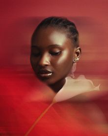 Artistic Portrait Of Woman With Red Blurred Background