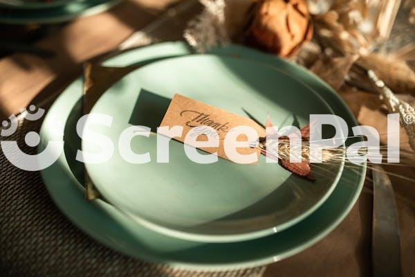 White And Brown Card On Green Ceramic Round Plate
