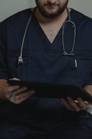 A Person Holding A Digital Tablet
