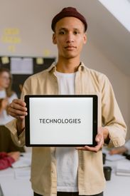 A Man Holding A Digital Tablet